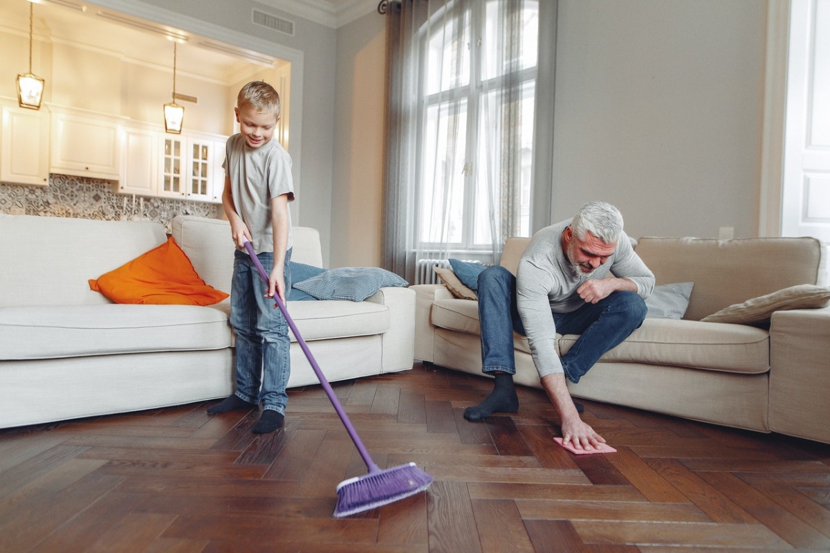 grandfather and child cleaning the floor