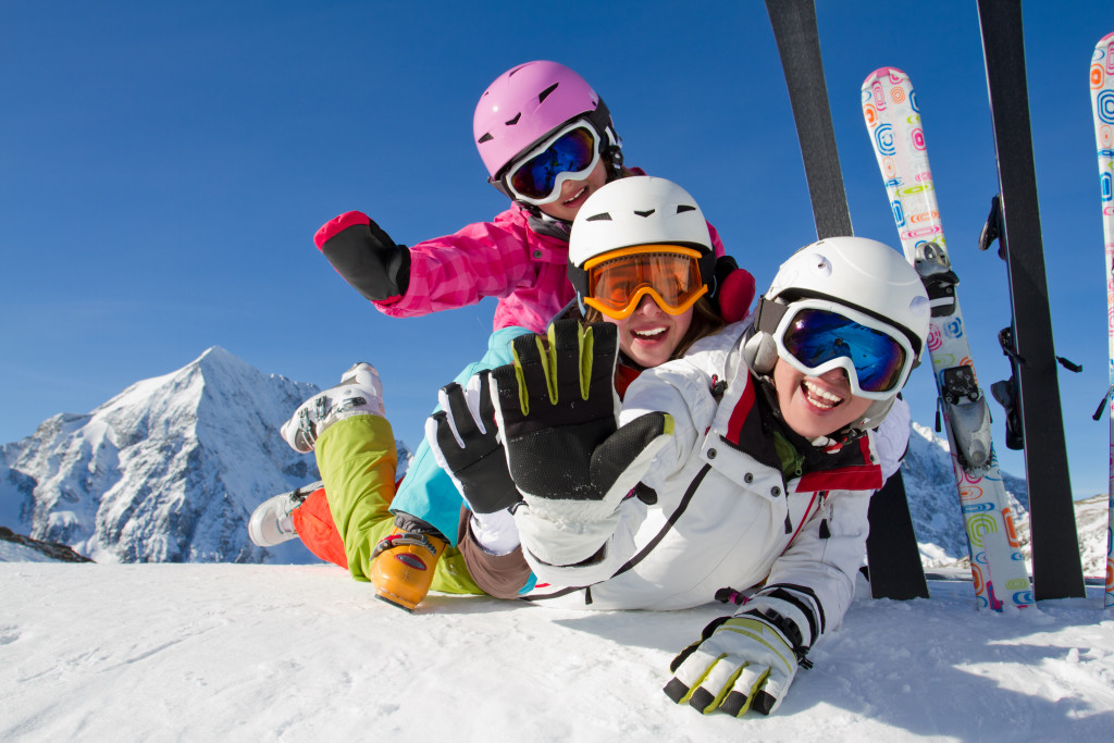 Winter, ski, snow and fun - family enjoying ski holiday