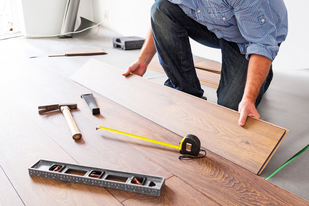 Man installing laminated wood floor