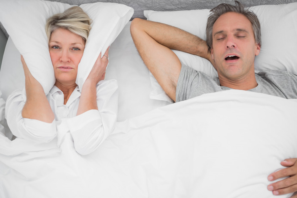 A loud snorer beside his wife