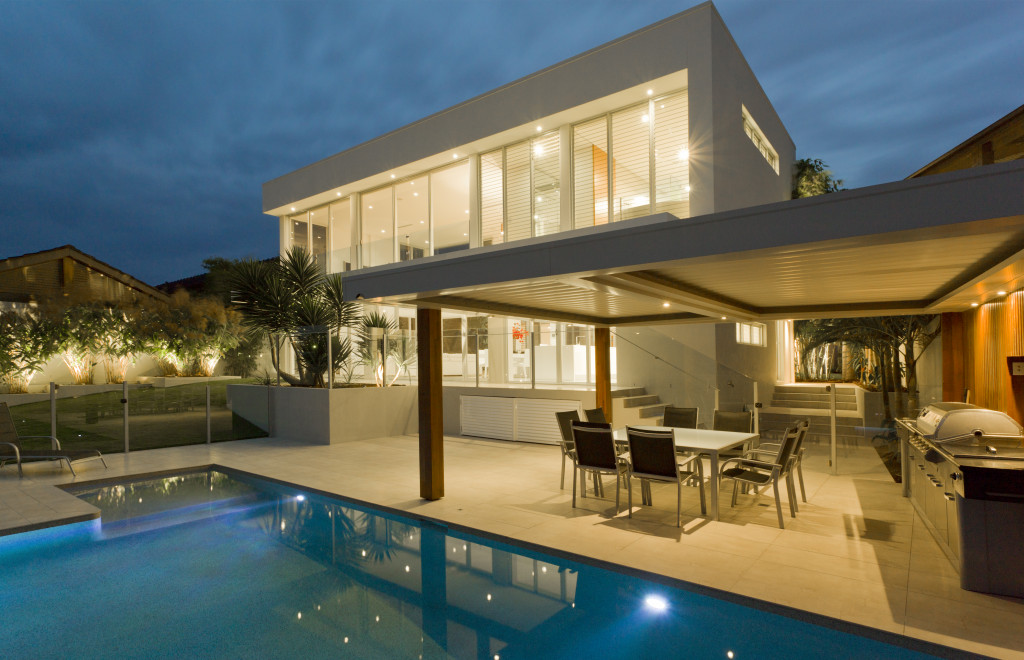 a modern house with a deck and swimming pool
